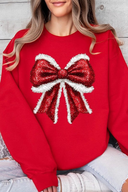 Person wearing a Christmas Santa Bow Graphic Fleece Sweatshirt in dark green, showcasing a large, glittery red and white Santa bow graphic on the front.