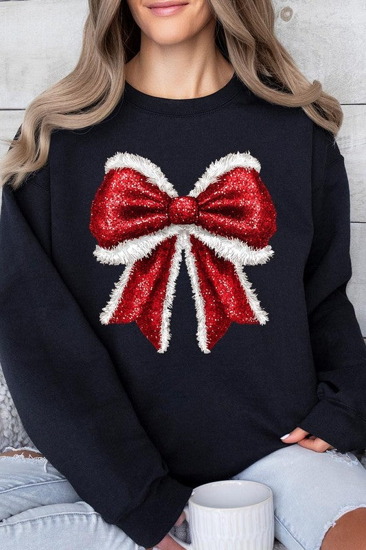 Person wearing a Christmas Santa Bow Graphic Fleece Sweatshirt in dark green, showcasing a large, glittery red and white Santa bow graphic on the front.