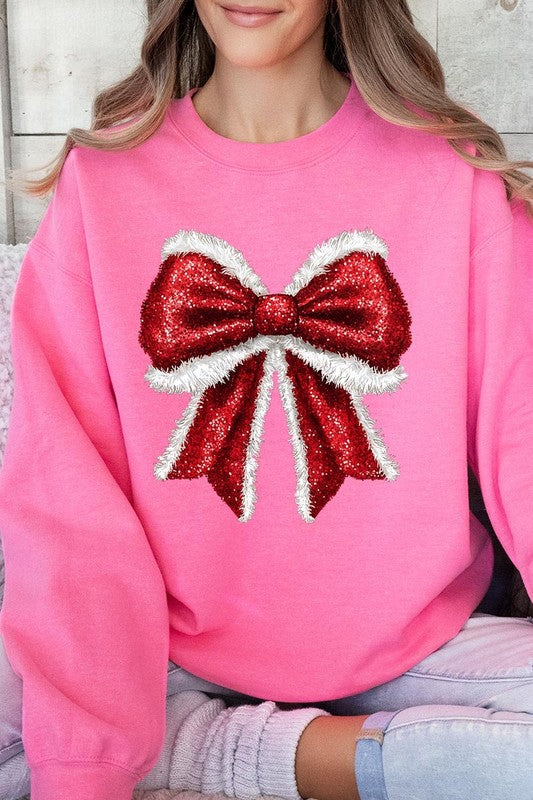 Person wearing a Christmas Santa Bow Graphic Fleece Sweatshirt in dark green, showcasing a large, glittery red and white Santa bow graphic on the front.