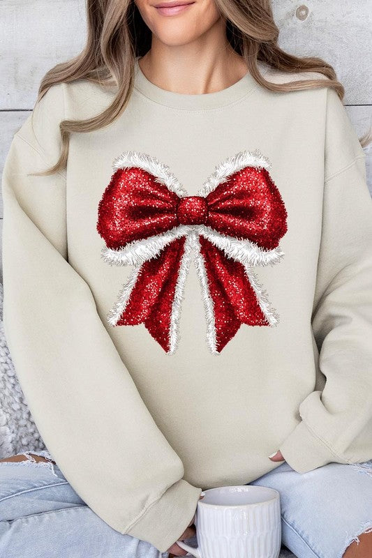 Person wearing a Christmas Santa Bow Graphic Fleece Sweatshirt in dark green, showcasing a large, glittery red and white Santa bow graphic on the front.