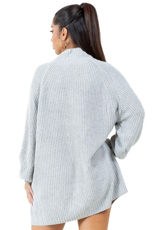 A person models the WOMEN FASHION SWEATER DRESS, a light gray turtleneck sweater dress with long sleeves, paired with tan ankle boots against a plain white background.