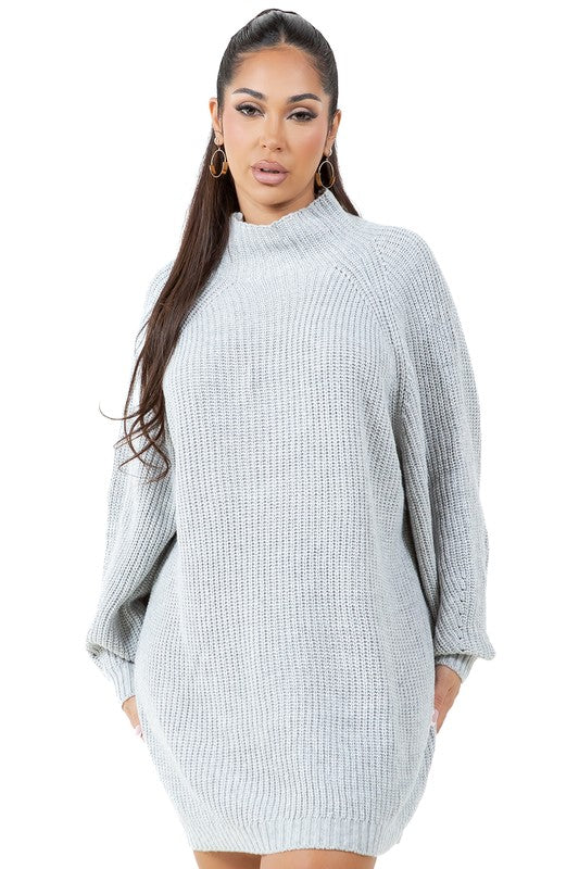 A person models the WOMEN FASHION SWEATER DRESS, a light gray turtleneck sweater dress with long sleeves, paired with tan ankle boots against a plain white background.