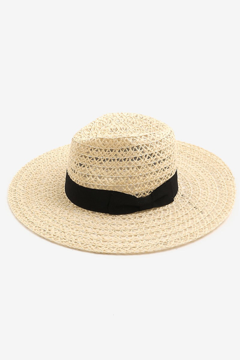 The Fame Wide Brim Straw Weave Sun Hat is designed with a wide brim and adorned with a black ribbon band, providing both stylish flair and superior sun protection.