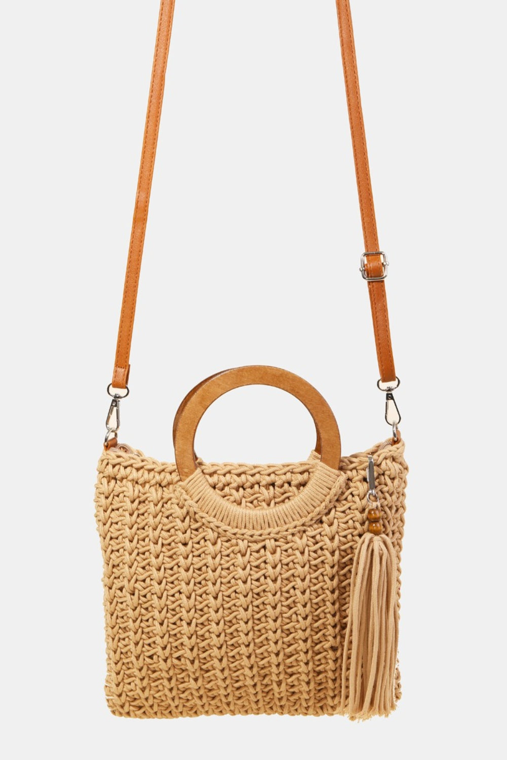 The Fame Crochet Knit Convertible Tote Bag includes a cream-colored design with round wooden handles and a matching tassel accent.