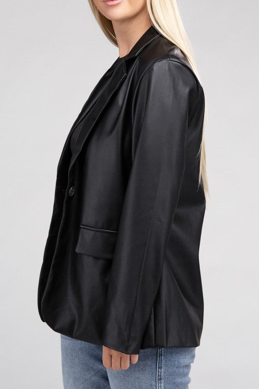 A person with long blonde hair wears the Sleek Pu Leather Blazer with Front Closure over a black top, standing against a plain background.