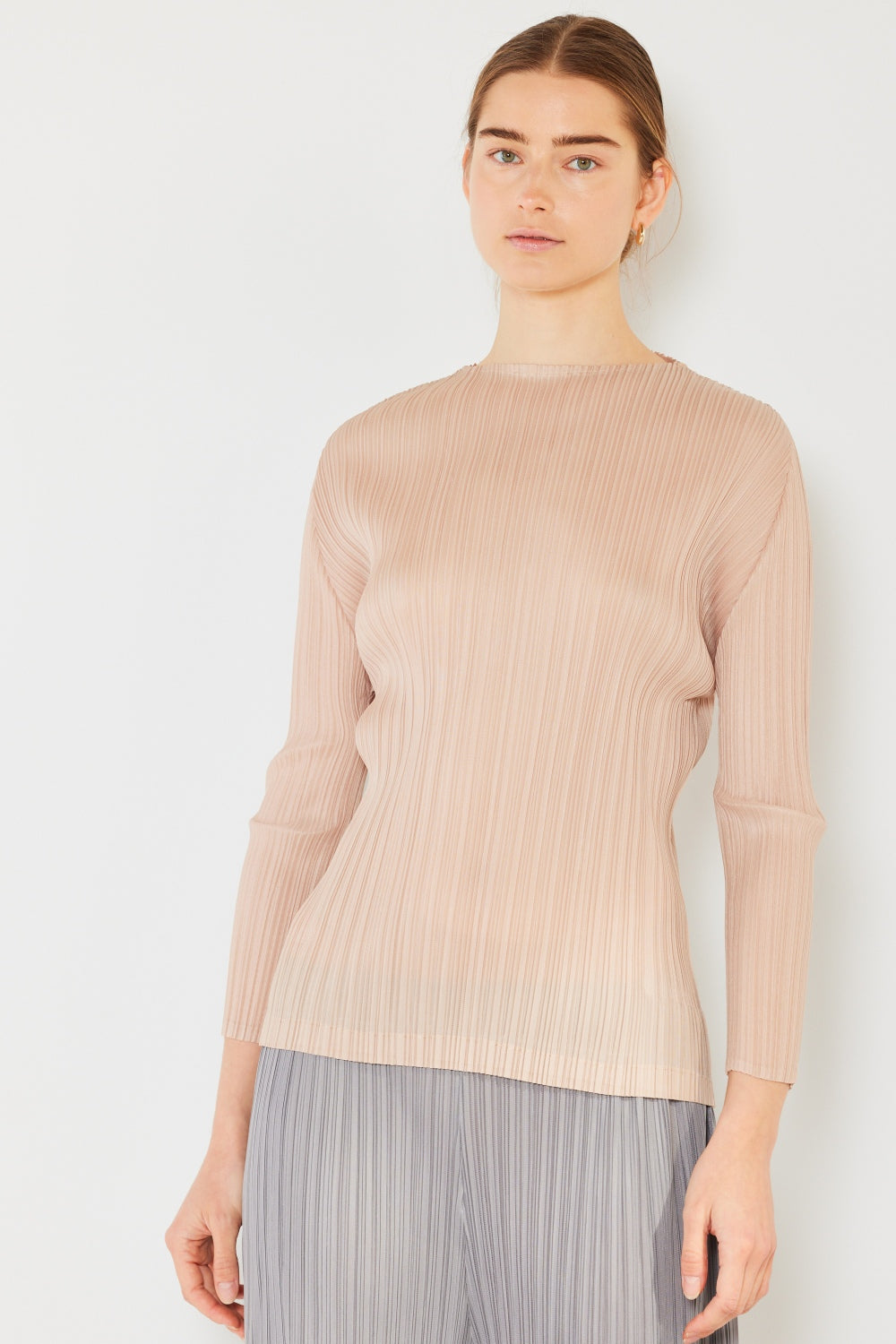 A person wearing the Marina West Swim Pleated Long Sleeve Boatneck Top with matching pants stands against a plain background.