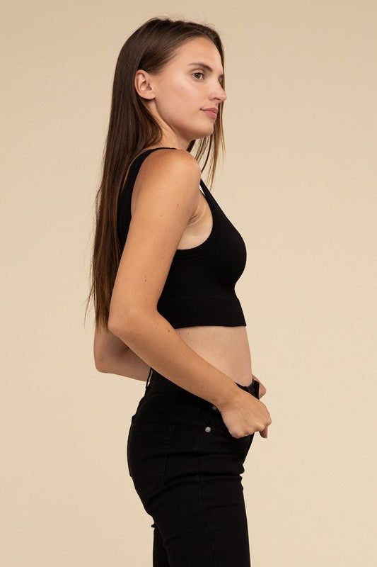 A person with long brown hair wearing the Ribbed Seamless Crop Top in light blue and black pants stands against a beige background, showcasing a perfect summer essential.