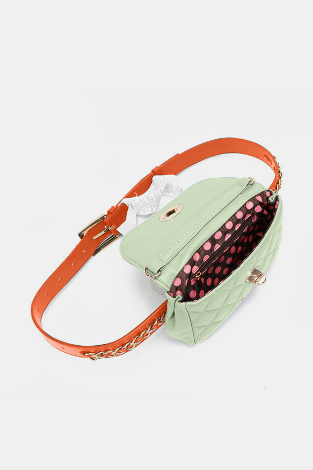 The Nicole Lee USA Quilted Fanny Pack is a light green, quilted crossbody bag crafted from vegan leather. It features gold hardware, including a twist-lock closure and a chain strap interwoven with orange leather accents. The brand name is visible on a gold plate at the front.