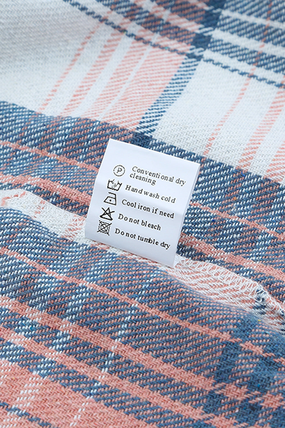 A woman wearing a white top, blue jeans, and the Gold Flame & Grey Plaid Button Up Collared Flannel Shacket smiles while posed outdoors.