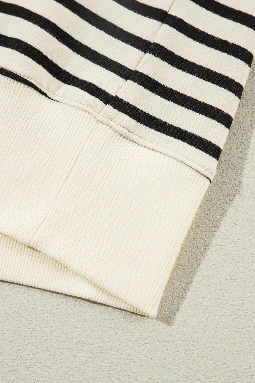 A person with long hair is facing away, wearing a Black Stripe CIAO AMORE Graphic Buttoned Pullover Sweatshirt and a black skirt in an indoor setting. The shirt subtly whispers "CIAO AMORE.