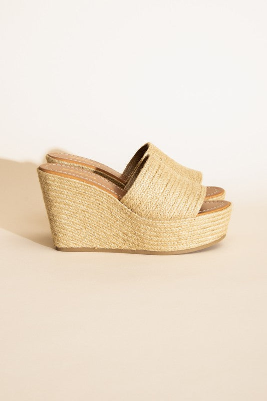 A pair of Bounty-S Wedge Platform Heels featuring a beige woven straw-like texture, open toe straps, and brown insoles.