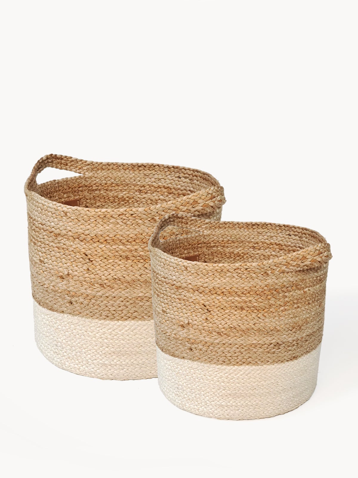 Two Kata Colorblock baskets with handles, featuring a two-tone design in natural and white fibers, crafted by Fair Trade artisans.