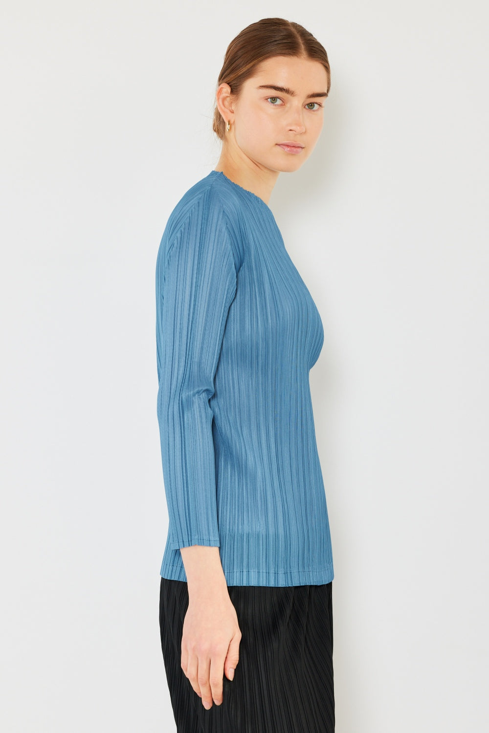 A person wearing the Marina West Swim Pleated Long Sleeve Boatneck Top with matching pants stands against a plain background.