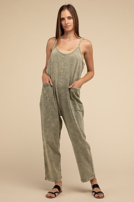 Woman standing and posing in a studio, wearing casual comfort style green Washed Spaghetti Straps Overalls with Pockets and sandals.