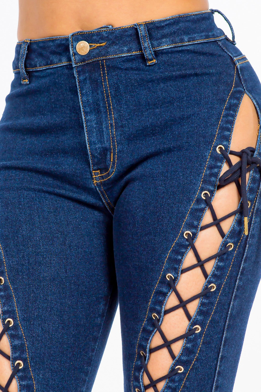 A pair of American Bazi High Rise Lace Up Jeans, featuring stylish denim and side detailing, worn by a person.