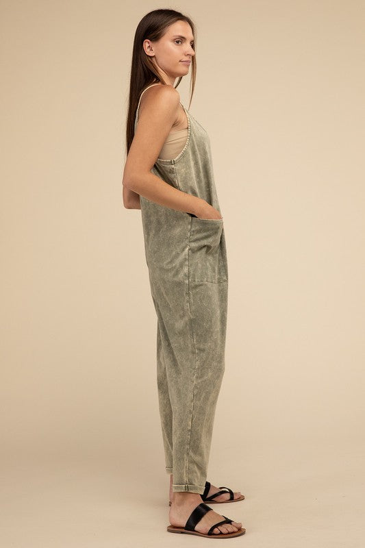 Woman standing and posing in a studio, wearing casual comfort style green Washed Spaghetti Straps Overalls with Pockets and sandals.