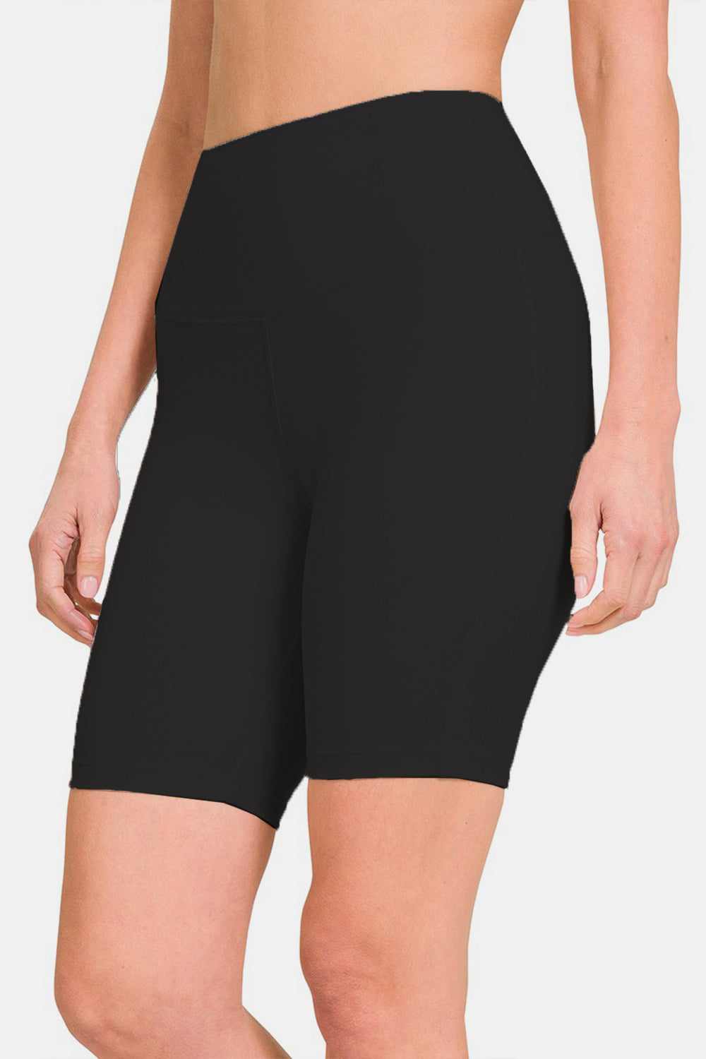 Close-up of a person wearing Zenana High Waist Active Shorts in black, designed with moisture-wicking fabric. The background is plain white.