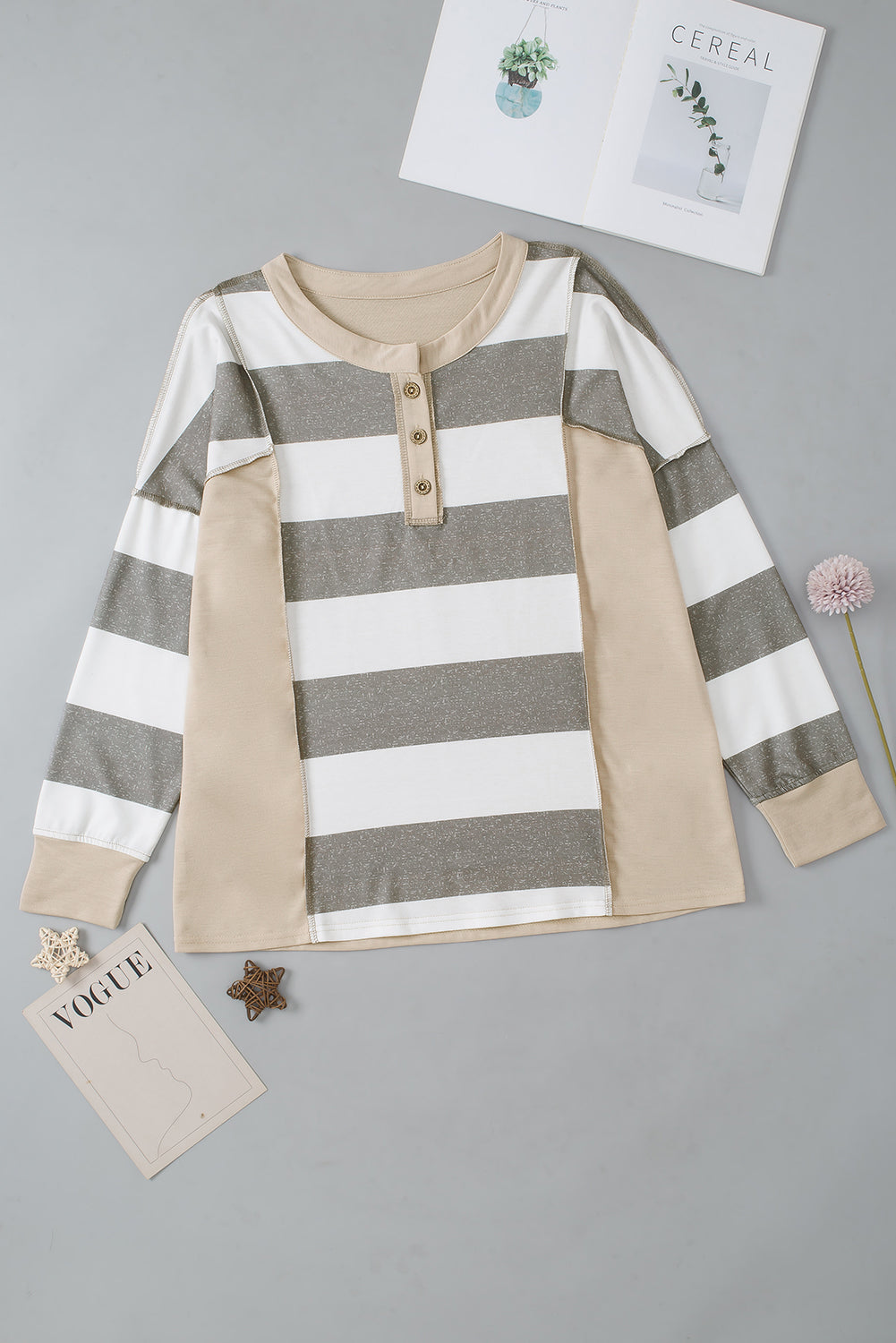 A person wearing a Multicolor Striped Colorblock Patchwork Sweatshirt paired with distressed blue jeans.