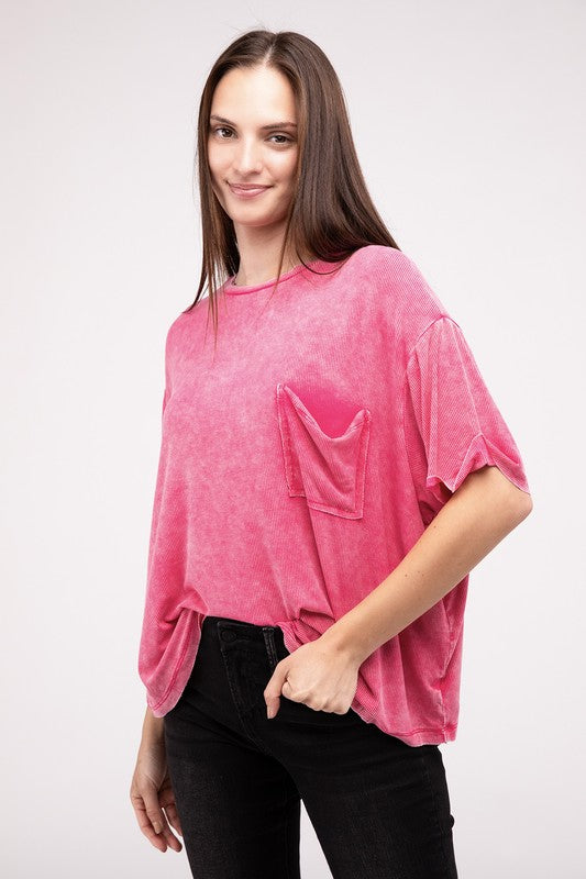 A person wearing a Washed Ribbed Cuffed Short Sleeve Round Neck Top in pink, paired with black pants, is standing against a plain background.