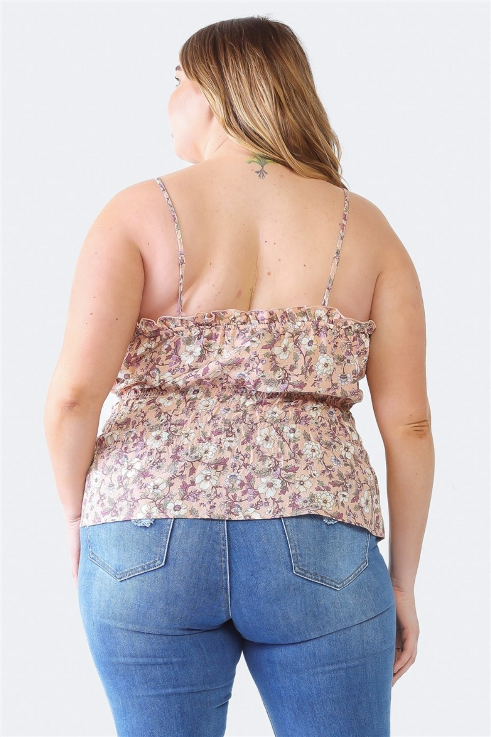 A person with long hair, wearing the Zenobia Plus Size Frill Floral Square Neck Cami and dark jeans, stands with one hand on their hip and the other relaxed by their side.