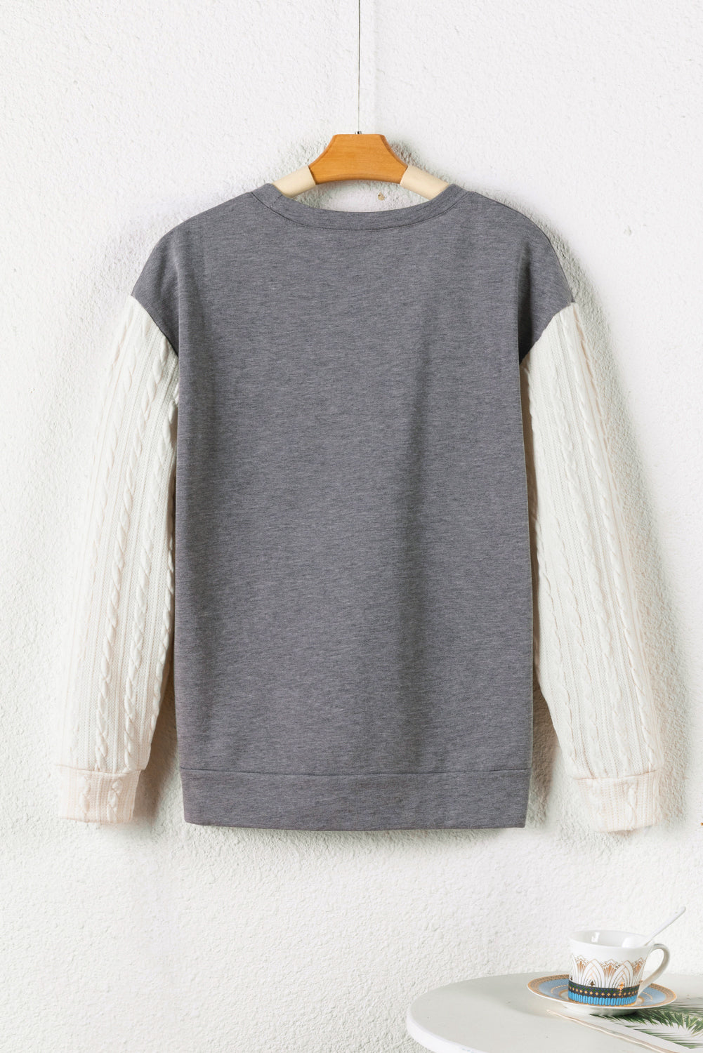 A person wearing a Dark Grey Cable Knit Sleeves Crew Neck Sweatshirt and a gold chain necklace is shown from the shoulders to the waist, standing outdoors.