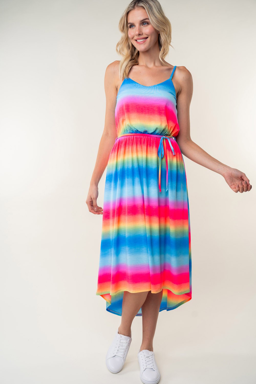 A person in a White Birch Full Size Ombre Striped Midi Cami Dress paired with white sneakers stands against a plain background.