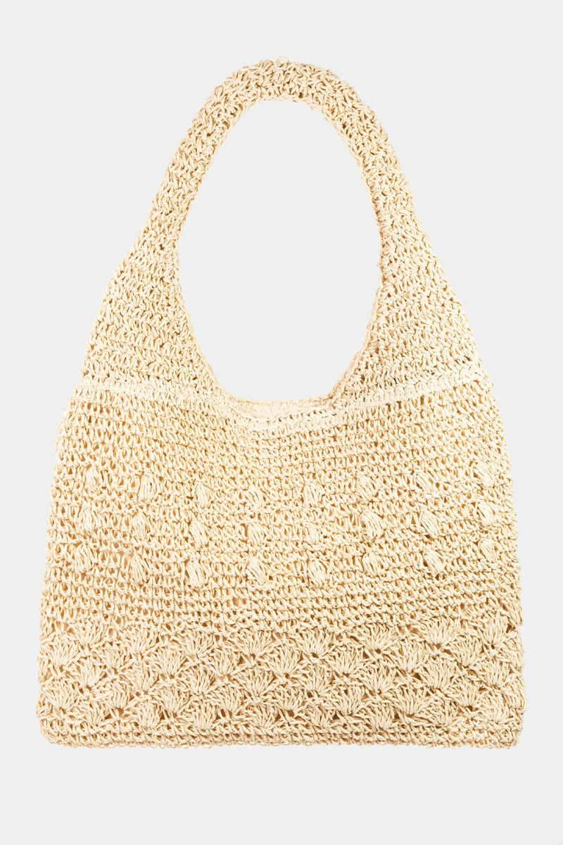 The Fame Straw Braided Tote Bag, featuring a simple pattern and single strap, is displayed against a plain background, exuding a chic and summery bohemian flair.