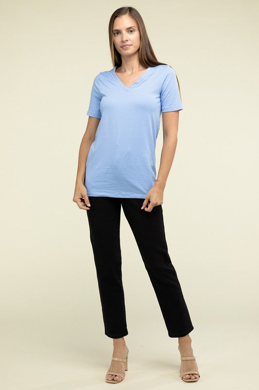 A person with long hair is standing and wearing a light blue Cotton V-Neck Short Sleeve T-Shirt and black pants.