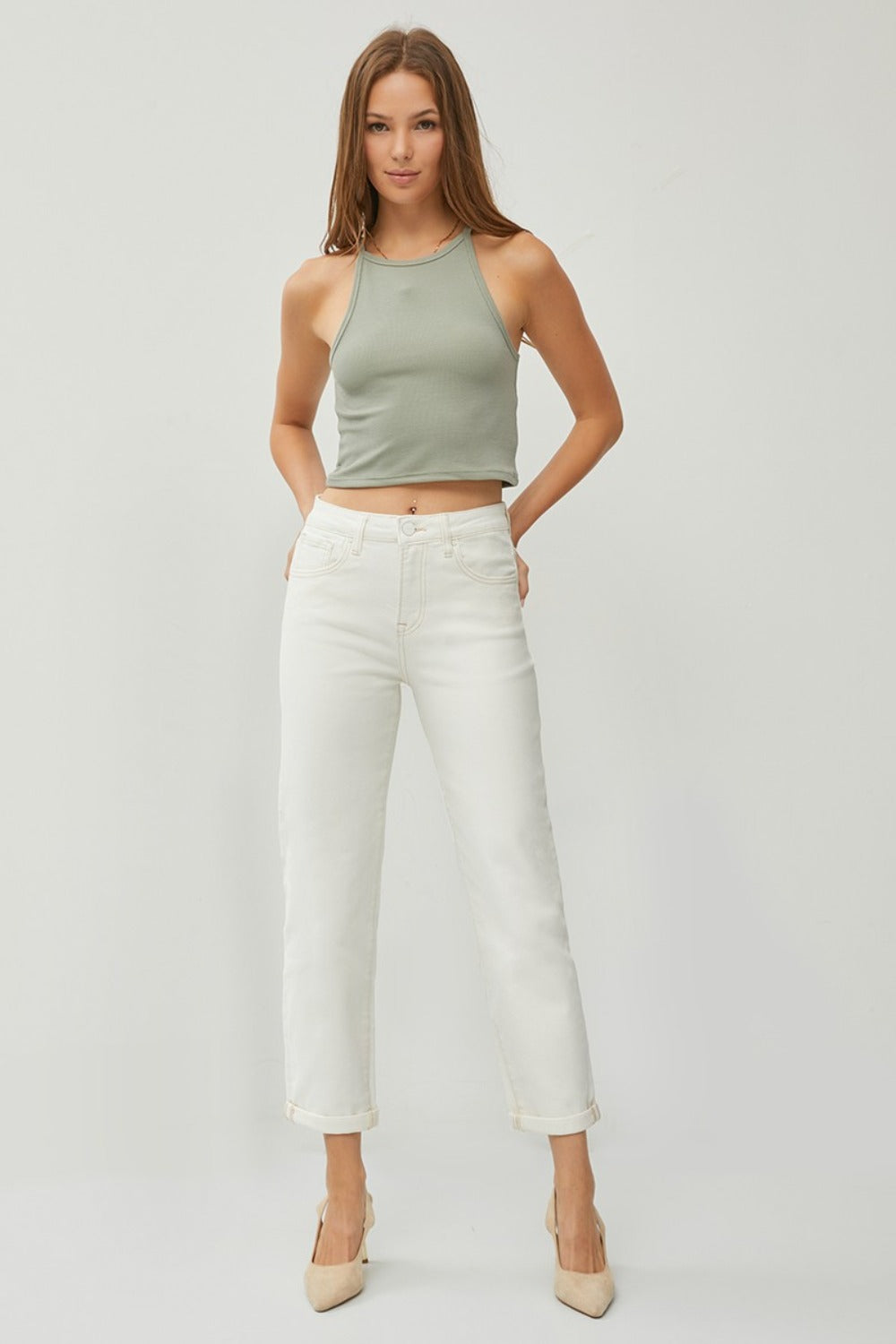 Description: Person wearing RISEN Full Size High Waist Rolled Hem Straight Jeans in white with beige heels against a plain background. 