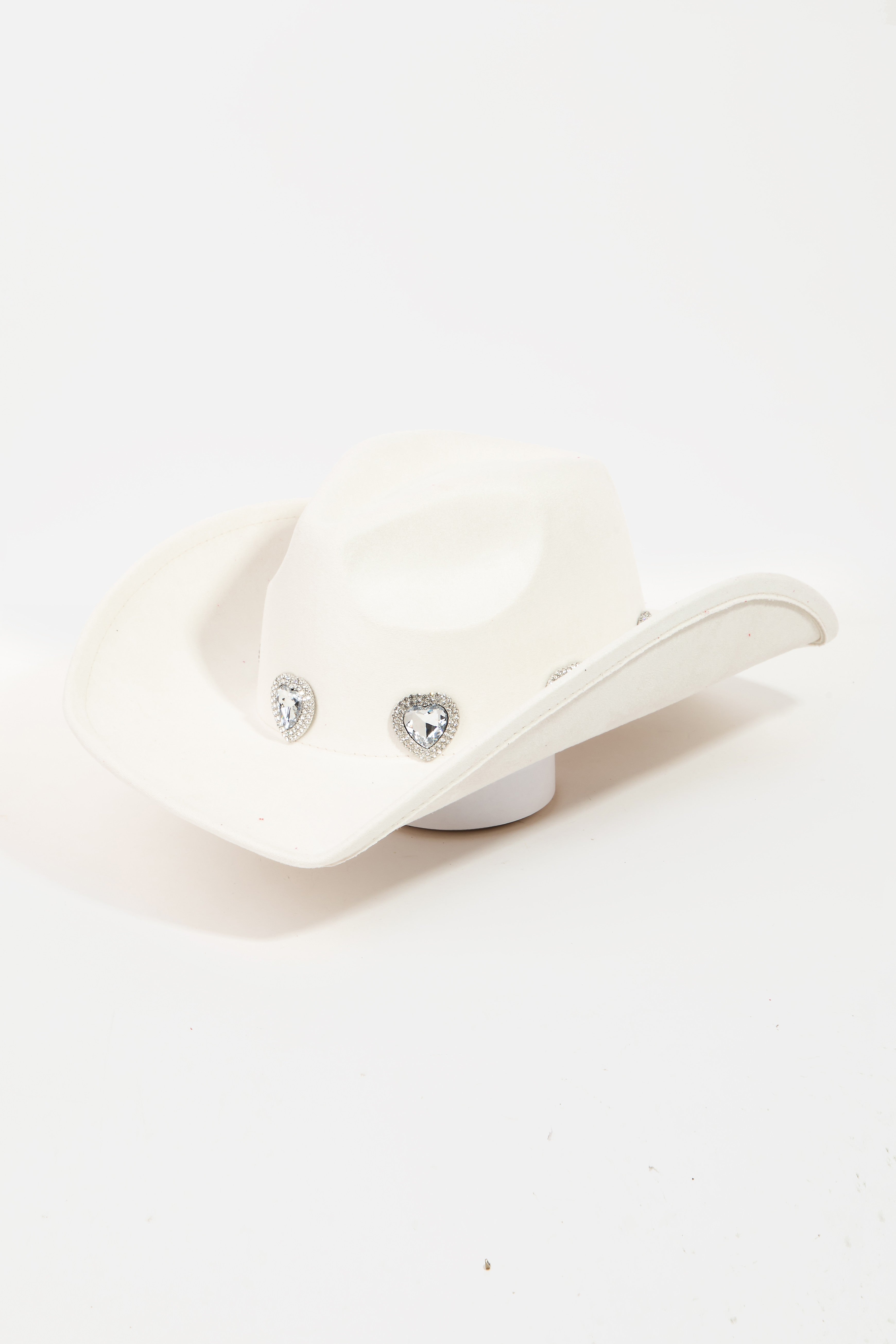 The Fame Rhinestone Pave Heart Cowboy Hat, a vibrant pink accessory made from durable polyester alloy, features three decorative silver embellishments on the front. It is showcased against a plain white background and includes an adjustable string to ensure a perfect fit for any head size.