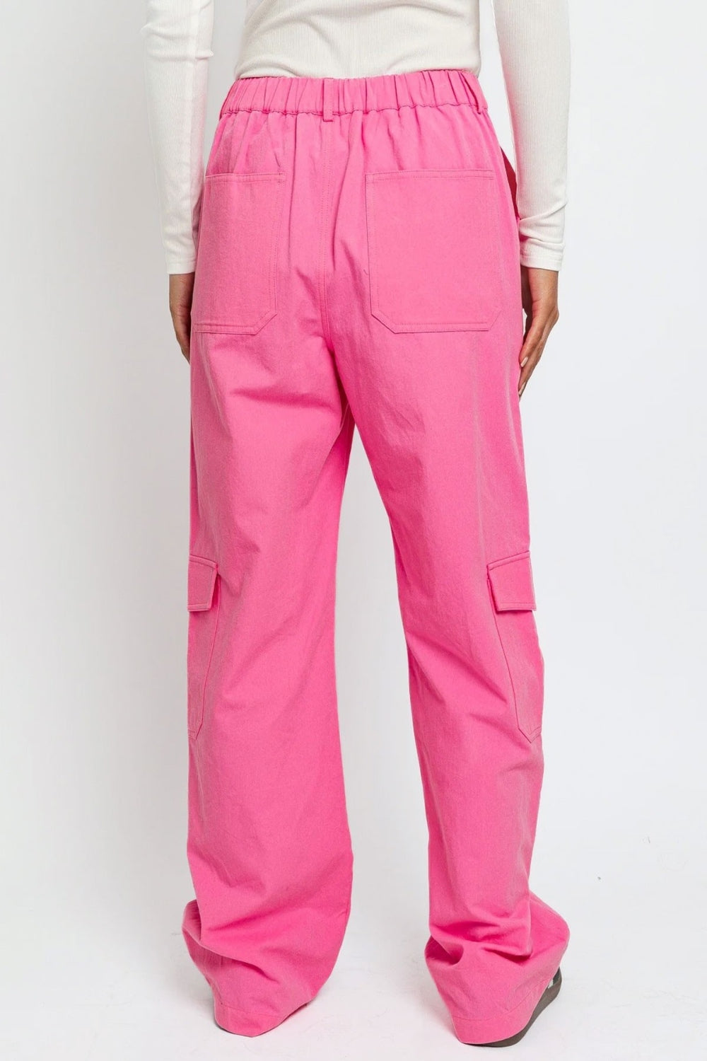   Person wearing the Le Lis High Waisted Wide Leg Cargo Pants with Pockets, featuring side pockets and zipper details, standing against a plain white background.