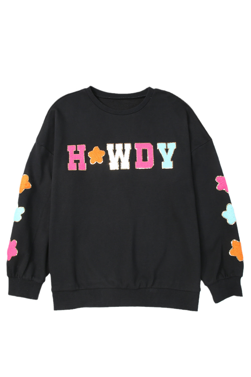 A woman with short blonde hair is wearing the Black Howdy Glitter Chenille Patch Graphic Casual Sweatshirt, featuring colorful star patterns and "WD" letters. She pairs it with light denim shorts and smiles while looking to the side.