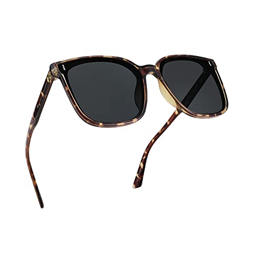 A pair of FEISEDY Women Oversized Vintage Polarized Sunglasses Square Cute Trendy Classic Simple Men B2758 with dark lenses and thin arms.