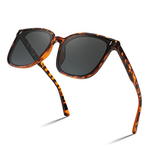 A pair of FEISEDY Women Oversized Vintage Polarized Sunglasses Square Cute Trendy Classic Simple Men B2758 with dark lenses and thin arms.