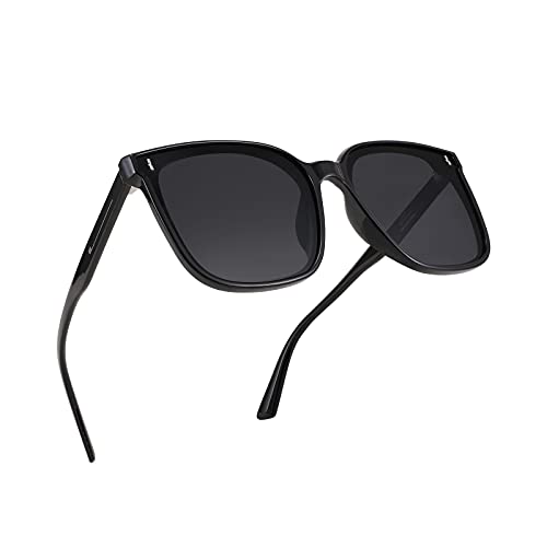 A pair of FEISEDY Women Oversized Vintage Polarized Sunglasses Square Cute Trendy Classic Simple Men B2758 with dark lenses and thin arms.