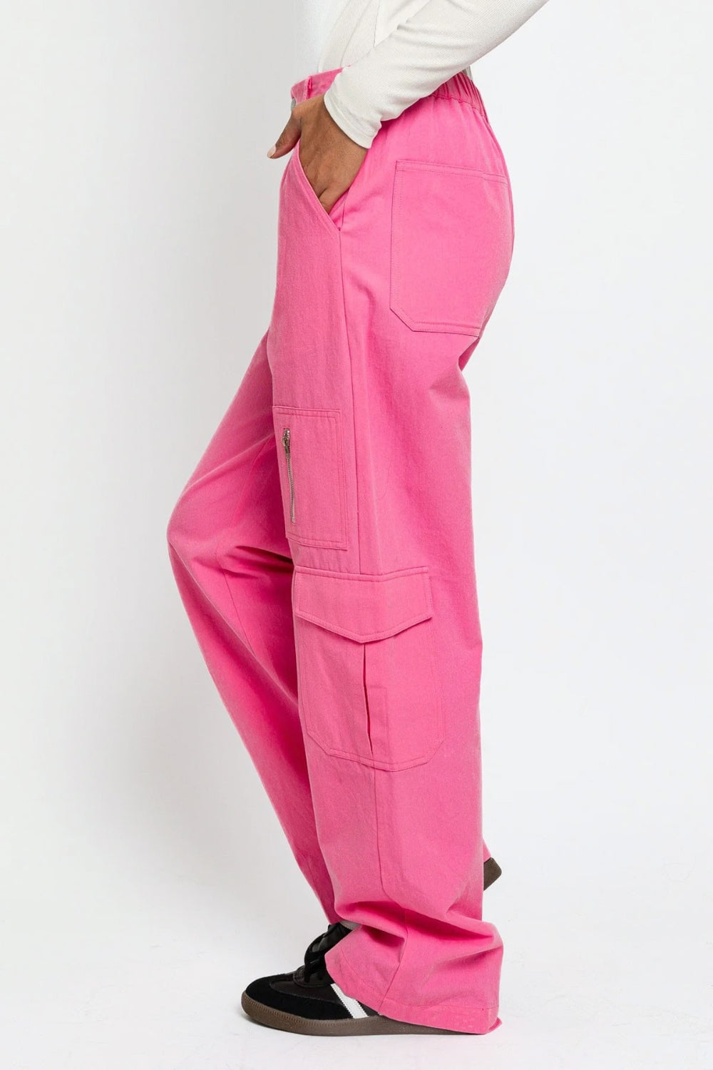   Person wearing the Le Lis High Waisted Wide Leg Cargo Pants with Pockets, featuring side pockets and zipper details, standing against a plain white background.