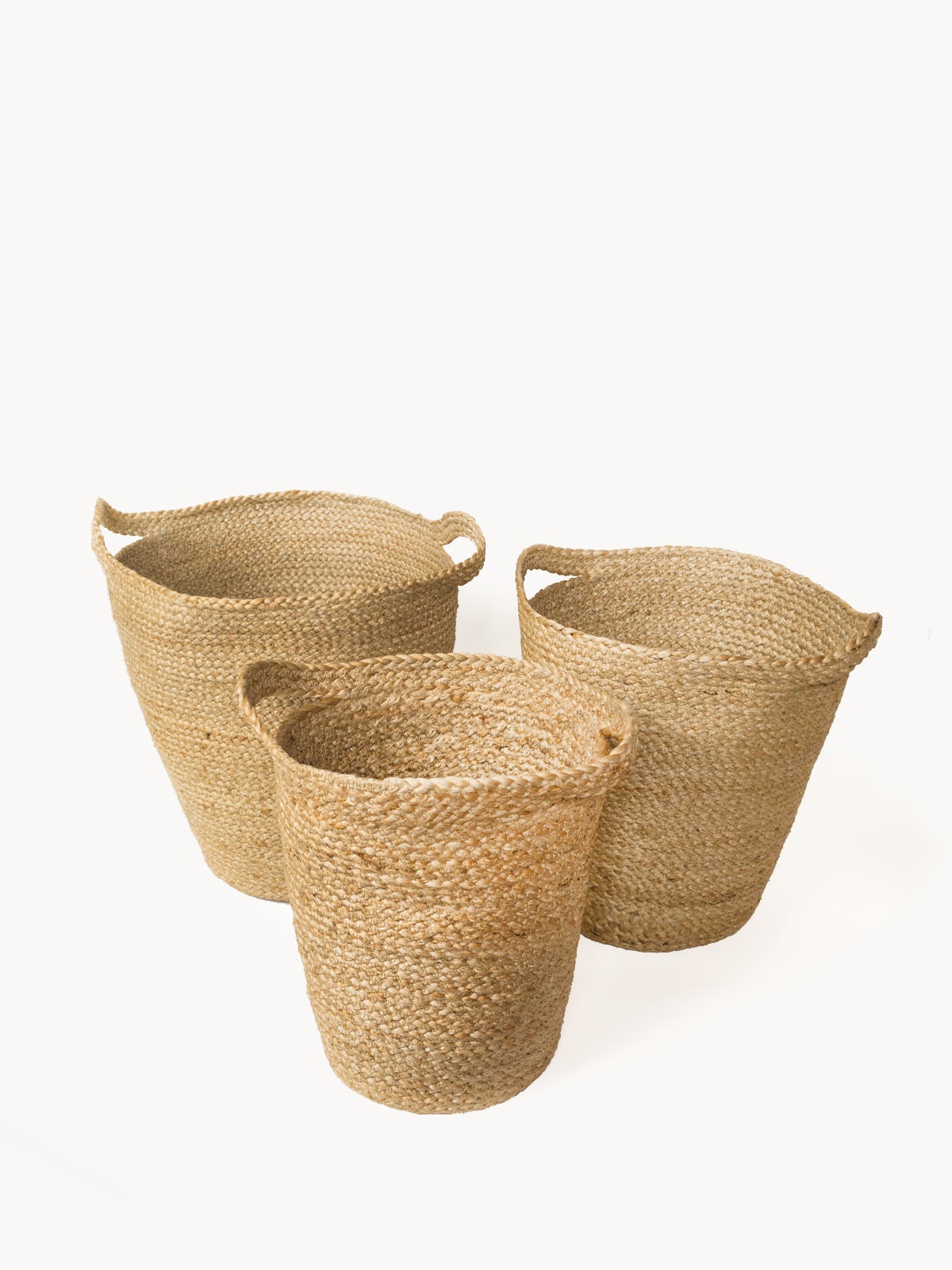 The Kata Basket with Slit Handle, crafted by Fair Trade artisans, is a set of three handwoven pieces that feature varying sizes and are elegantly displayed against a white background.