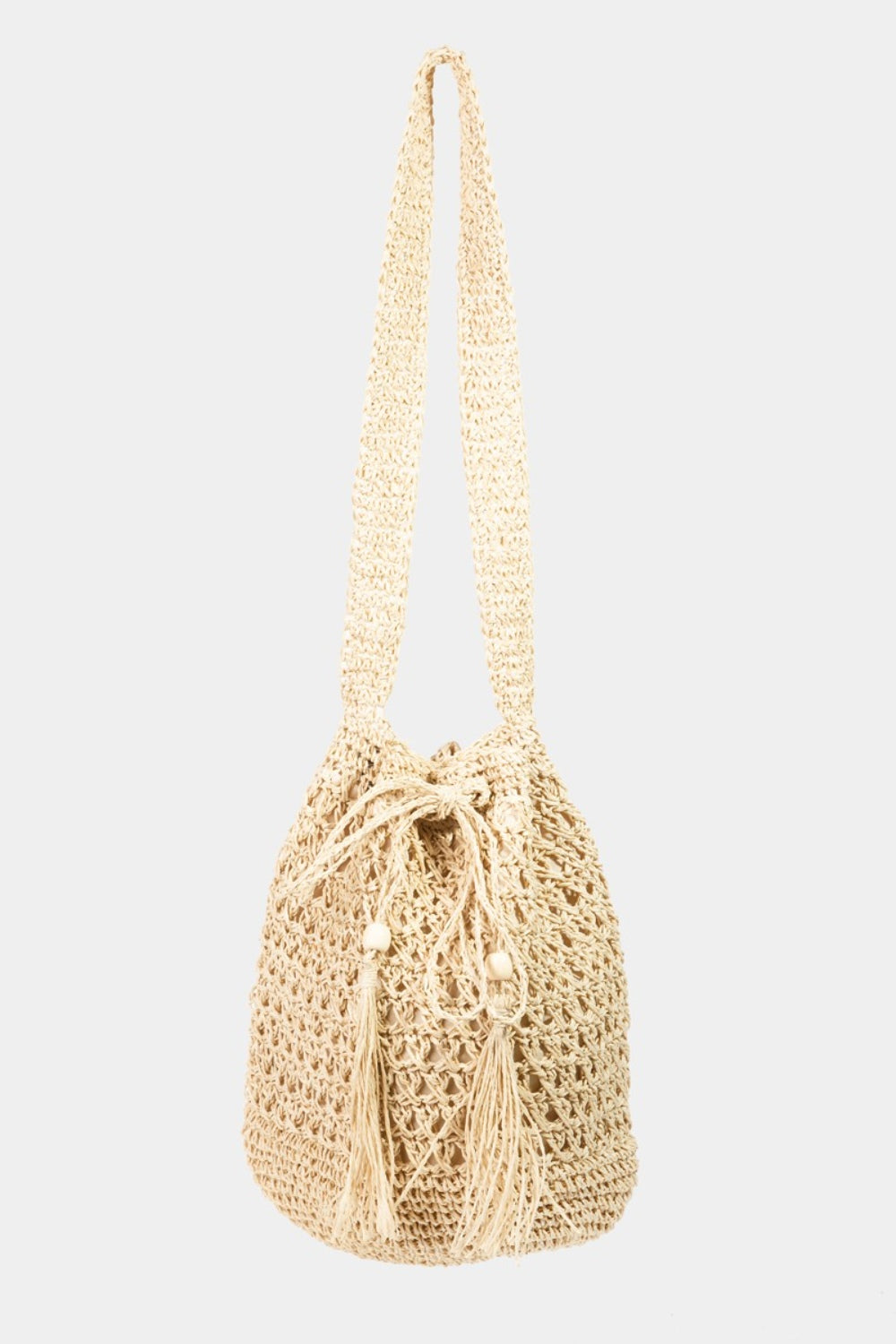 Fame Straw Braided Drawstring Tote Bag with Tassel in beige, highlighted by its crochet-like texture and a practical drawstring closure.