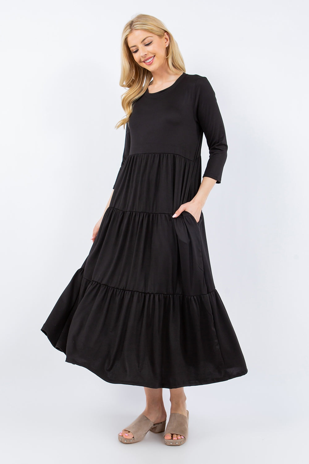 A person wearing the Celeste Full Size Tiered Midi Dress with pockets stands against a neutral background.