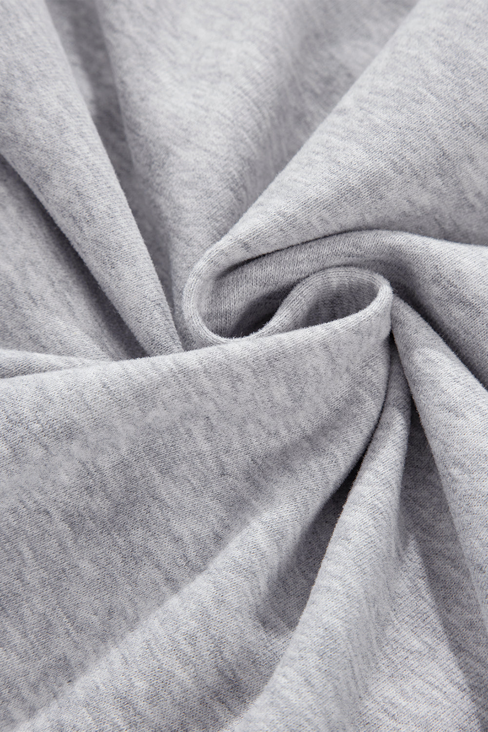 A woman with long, dark hair stands sideways, wearing a Light Grey Quarter Zip Stand Neck Kangaroo Pocket Sweatshirt that is perfect for layering, along with black shorts. She looks at the camera against a plain background, making this outfit ideal for casual occasions.