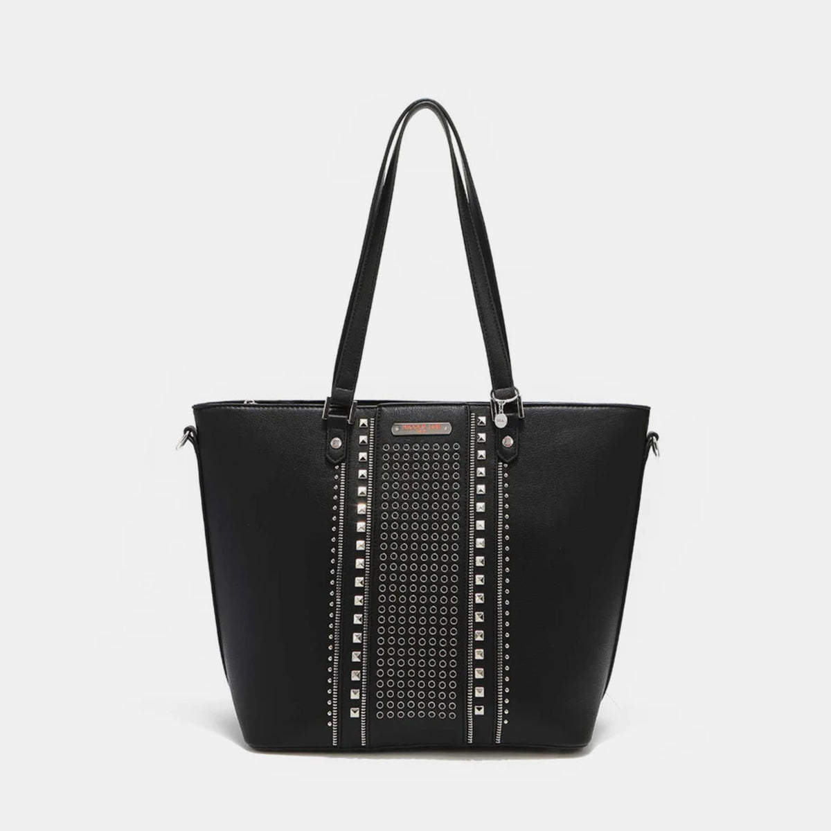 The Nicole Lee USA Studded Decor Tote Bag boasts a trendy appeal with its vegan leather material, highlighted by silver studs and dual shoulder straps, showcased against a white background.