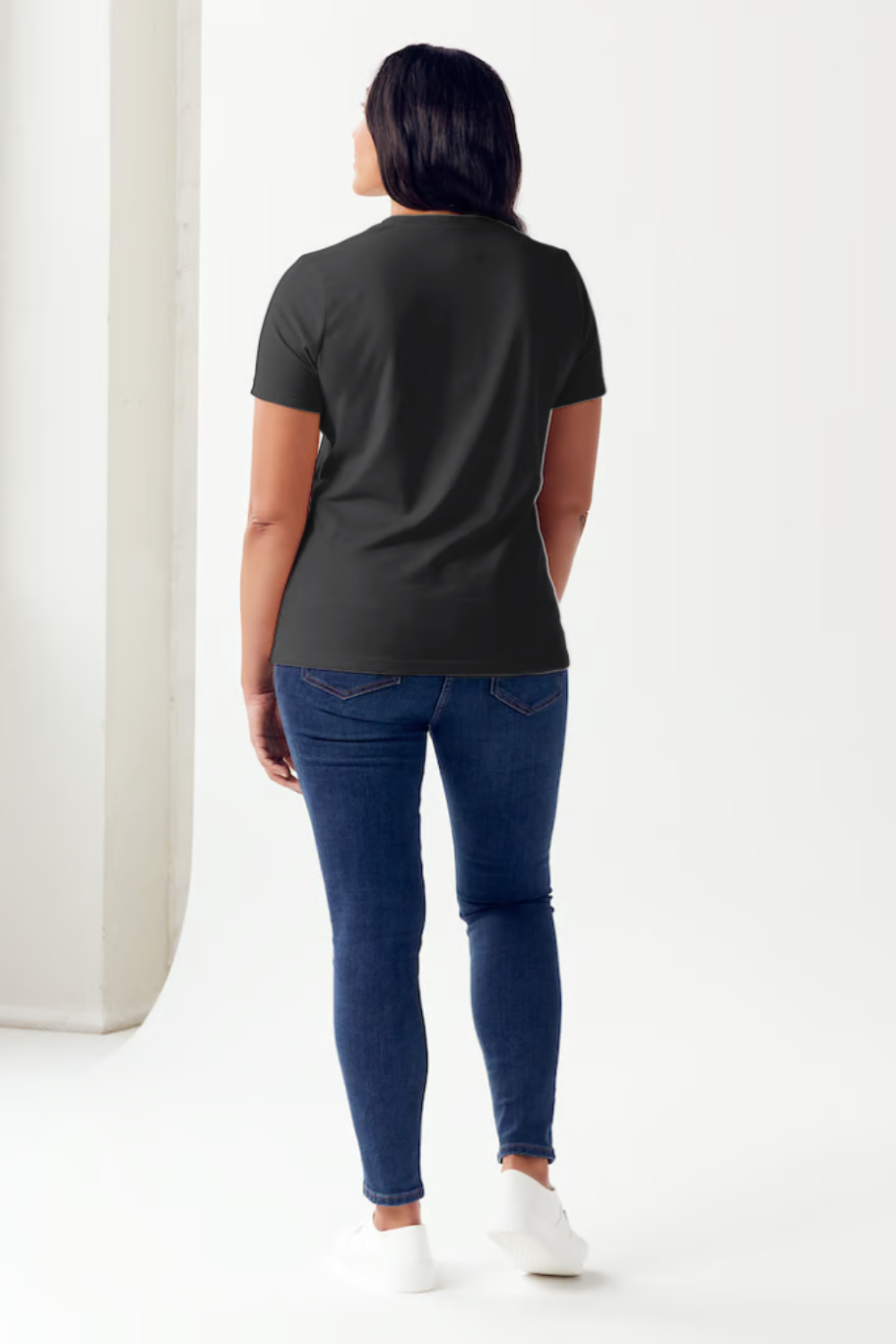 A person is wearing a Simply Love Full Size Slogan Graphic Short Sleeve Tubular T-Shirt, featuring a minimalist design of two hands reaching for each other. The text reads: "See the good in yourself and in others," delivering a positive message to all who see it.