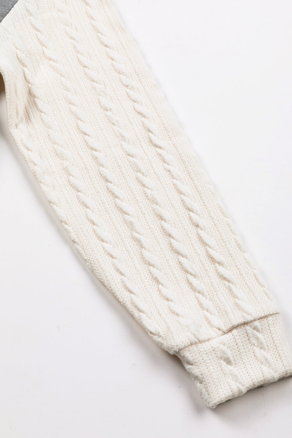 A person wearing a Dark Grey Cable Knit Sleeves Crew Neck Sweatshirt and a gold chain necklace is shown from the shoulders to the waist, standing outdoors.