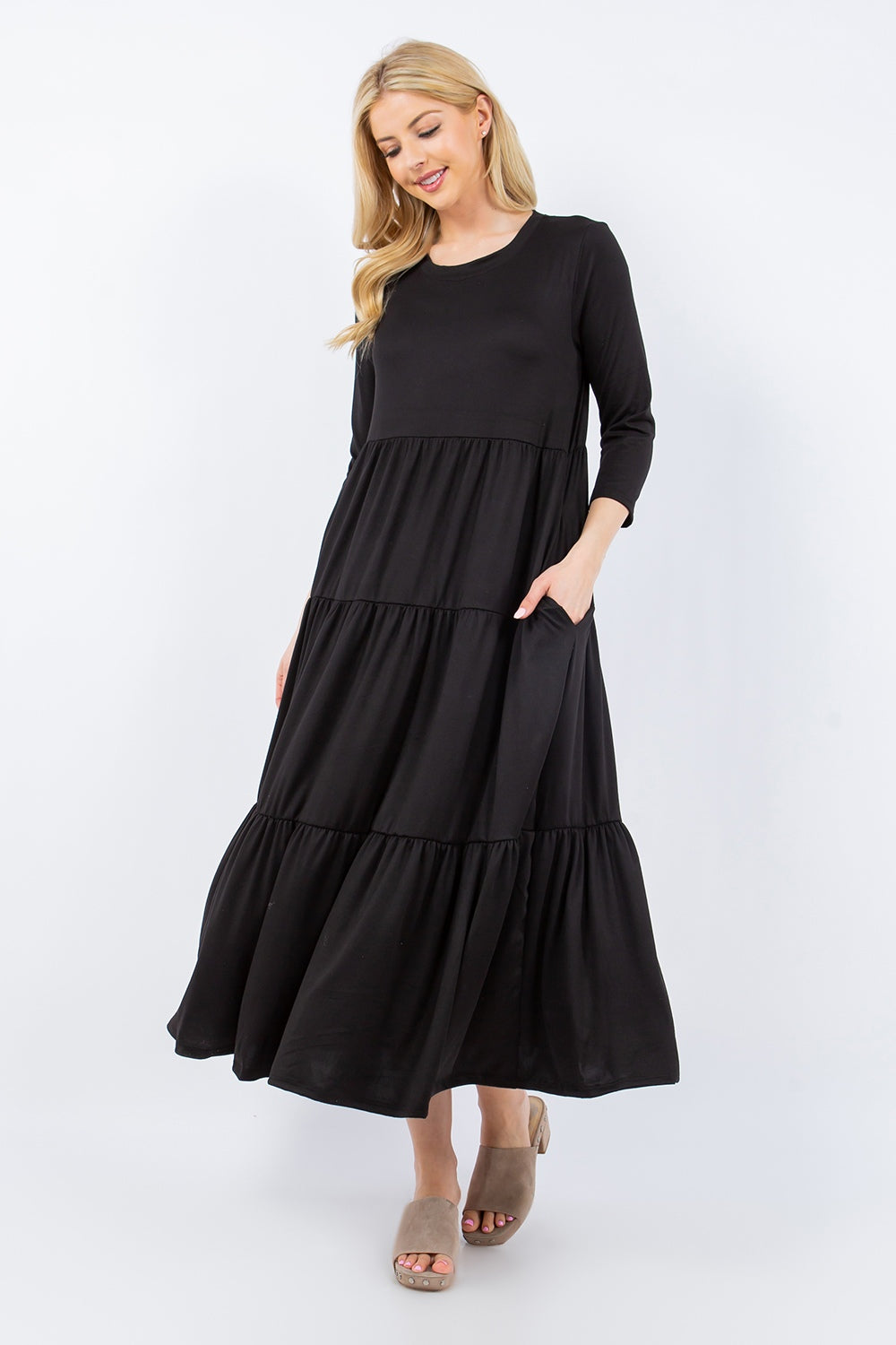 A person wearing the Celeste Full Size Tiered Midi Dress with pockets stands against a neutral background.