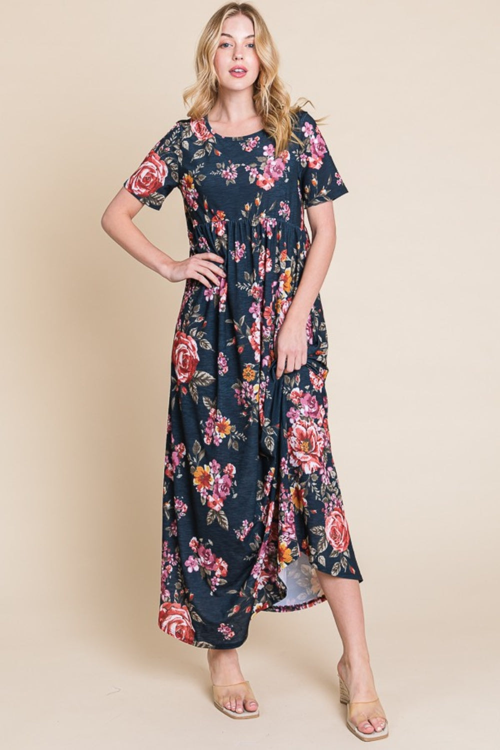 A person wearing the elegant BOMBOM Floral Short Sleeve Maxi Dress, featuring a long and flowy silhouette, stands against a plain background.