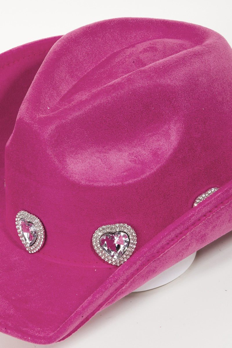 The Fame Rhinestone Pave Heart Cowboy Hat, a vibrant pink accessory made from durable polyester alloy, features three decorative silver embellishments on the front. It is showcased against a plain white background and includes an adjustable string to ensure a perfect fit for any head size.