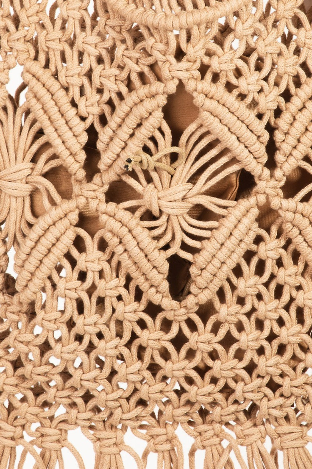 Introducing the Fame Woven Handbag with Tassel: a handmade beige macramé bag showcasing a braided strap and floral pattern, complete with tassel details at the bottom for a bohemian vibe.