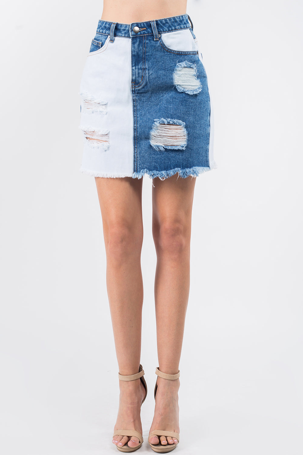 A woman is wearing an American Bazi Contrast Patched Frayed Denim Distressed Skirt, paired with beige ankle-strap heels.