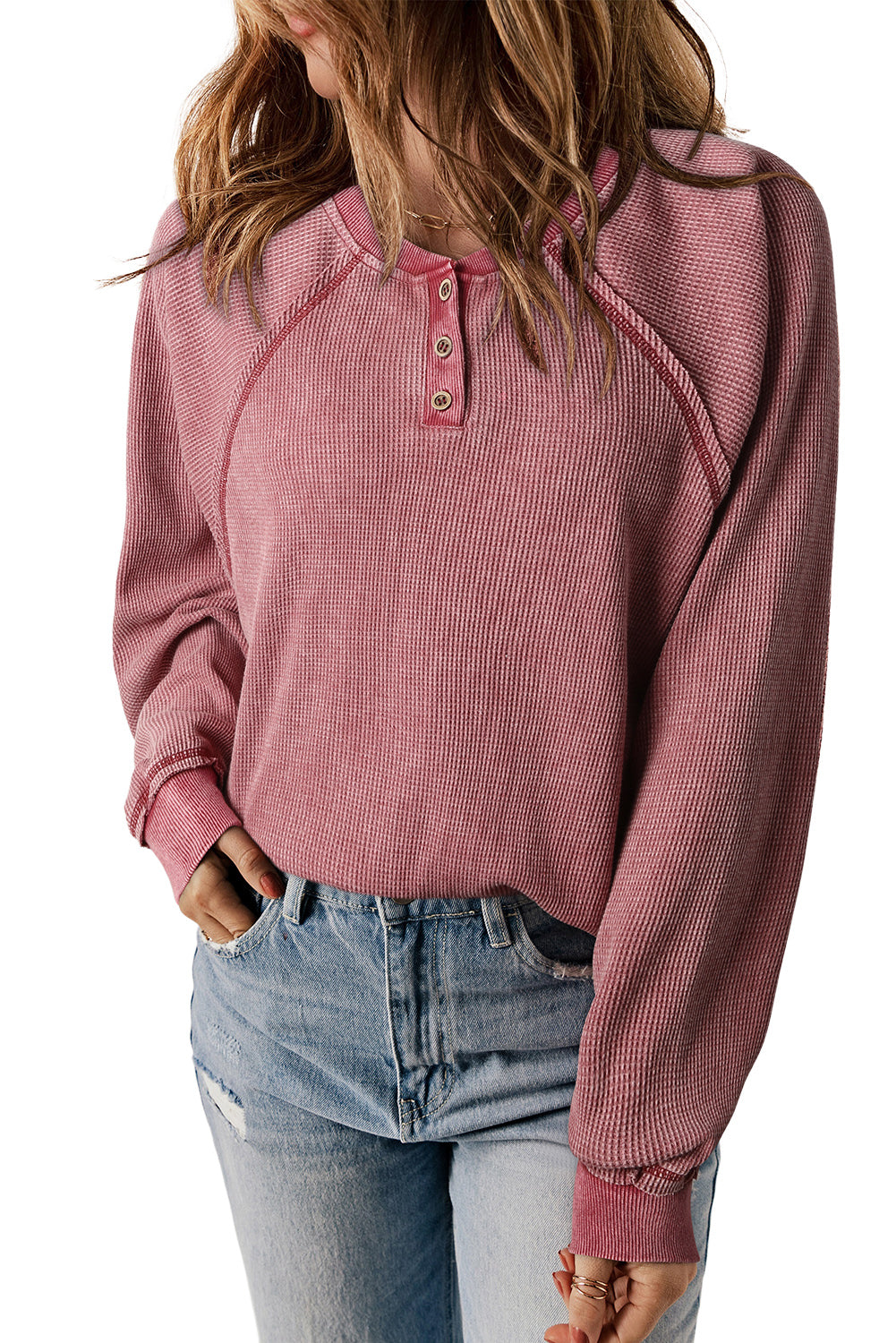 A person with long, wavy hair wearing a Fiery Red Waffle Knit Raglan Sleeve Henley Sweatshirt and light blue distressed jeans is shown from the back against a plain background.