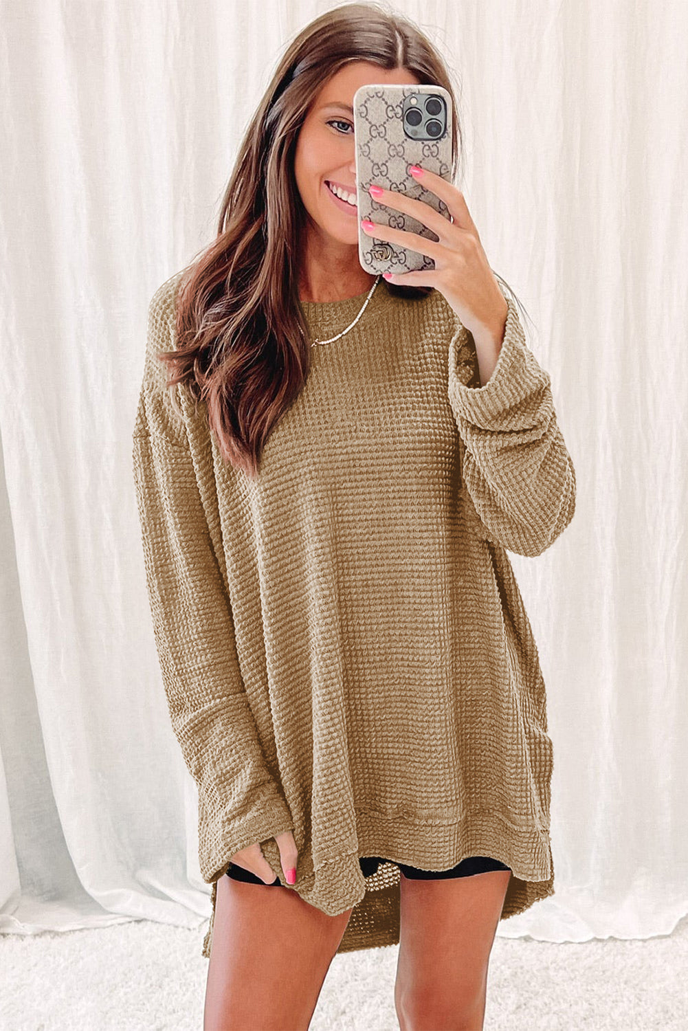 Person wearing a trendy Green Waffle Knit Drop Sleeve High Slits Oversized Top takes a mirror selfie, showcasing the cozy waffle knit texture along with their upper and part of their lower body.